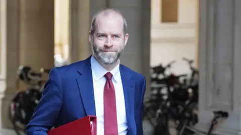 PA Media Business secretary Jonathan Reynolds in a suit and tie