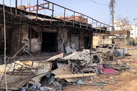 Getty Images This picture taken on May 30, 2024, shows damaged shops in Omdurman