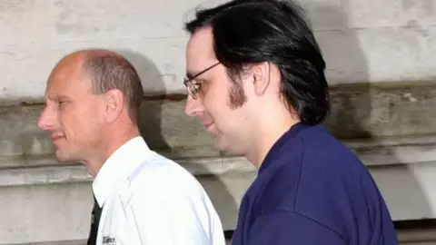 MEDIA WALES Two men, one in a white shirt and the other in a blue t-shirt with glasses