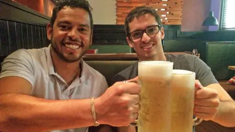 Brazil police Daniel Guerra (L) and Rodrigo Dantas (R) holding beers in 2017