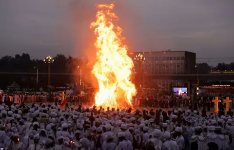 Tiksa Negeri / Reuters Ethiopian Orthodox faithful stand next to a bonfire during the Meskel festival,