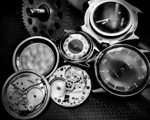 Ivan Bush A collection of old watches - some taken apart to expose the insides of them.