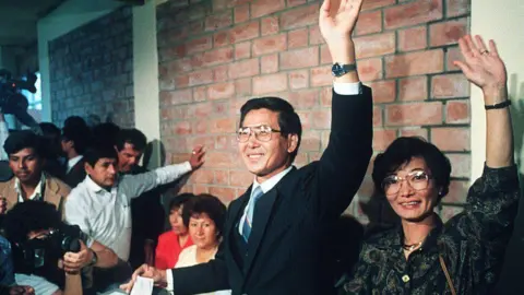 AFP Alberto Kenyo Fujimori, presidential candidate for the "Cambio 90" party, and his wife Susana, salute 10 June 1990 in Lima