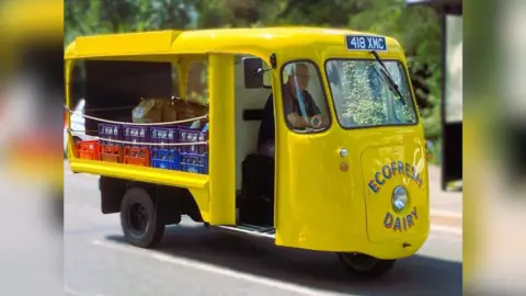 Paul Luke Paul Luke driving a yellow milk float