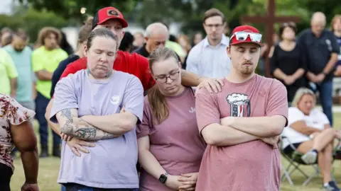 EPA People holding each other at the vigil