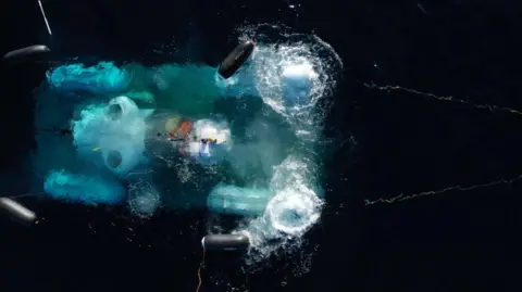 Submersible launched into the ocean to the sight of Titanic, seen from above as it leaves mother ship