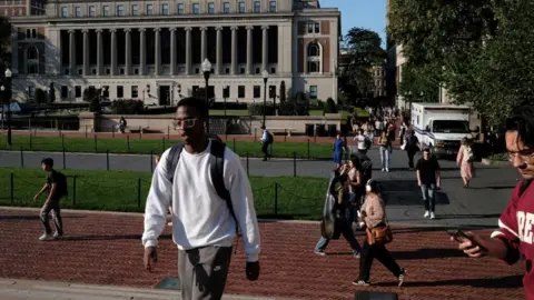 Reuters Students walk through Columbia University's campus appearing unbothered by the protest occurring outside the school's gates. 