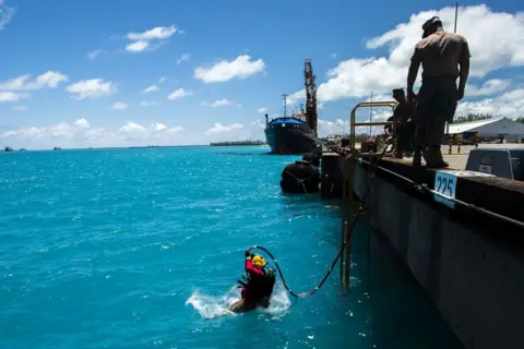 Alamy US Navy personnel carry out maintenance work at the Diego Garcia military base