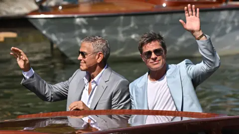 Getty Images Cast members Brad Pitt and George Clooney arrive via boat to the premiere of "Wolfs" out of competition, at the 81st Venice Film Festival, Venice, Italy, September 1, 2024