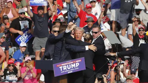 EPA Trump was defiant in the moments after being struck by a bullet at a rally in July