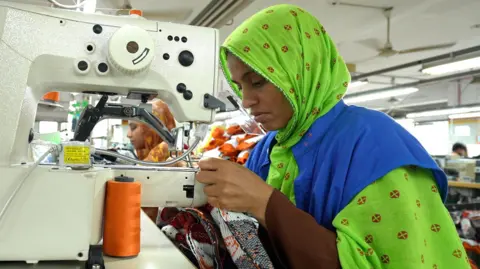 BBC Textile workers in a garment factory in Bangladesh.