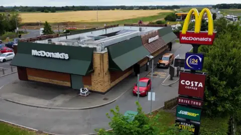 BBC An aerial view of the McDonald's in Caxton in Cambridgeshire where the victims worked