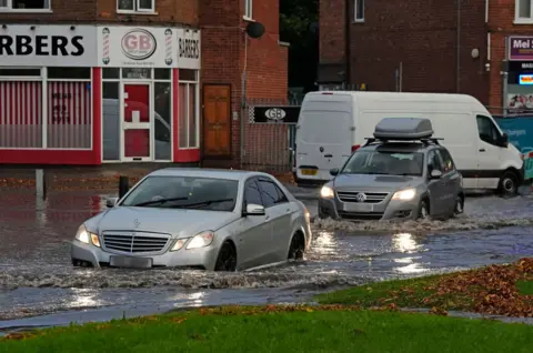 PA Media Cars drive on road in Birmingham 