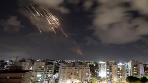 Reuters Israel's Iron Dome anti-missile system intercepts rockets in the dark skies over the city of Ashkelon