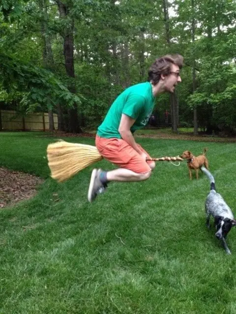 Philip Marchington Man jumps with broom between his legs to mimic flying