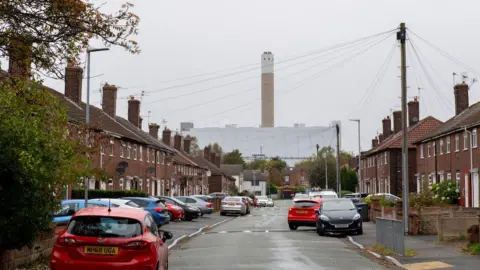 BBC / Jon Parker Lee The waste incinerator at Runcorn, seen at the end of a street with houses on either side