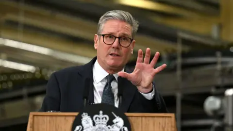 Getty Images Keir Starmer speaks during a visit to the Encirc Glass factory in Chester