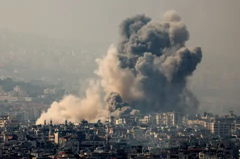 Reuters A cloud of smoke rises over Dahieh after a strike. Israel has bombed the suburb at least 54 times over the past few weeks.