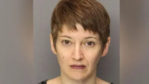 Essex County Correctional Facility Anna Stubblefield in an image which appears to be a mug shot. She is looking directly at the camera and has short brown hair. 