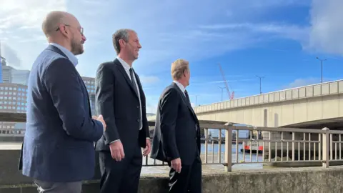 From left: Chris Earlie, head of Tower Bridge at City Bridge Foundation, Michael McCulloch and Lake Havasu City, Cal Sheehy revisiting the bridge