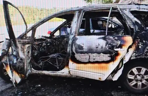 Israeli police An Israeli police picture of a burnt-out car, allegedly the result of an arson attack 