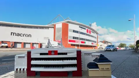 @minibrickarchitecture A Lego model of Racecourse Ground and nearby pub, The Turf, sat in front of the actual ground 