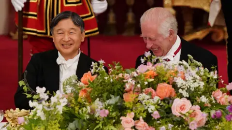 Getty Images King Charles talks with Emperor Naruhito of Japan during the State Banquet at Buckingham Palace.