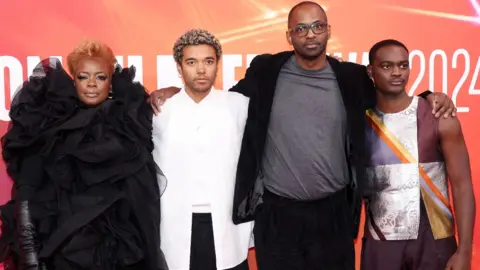 Getty Images Aunjanue Ellis-Taylor, Brandon Wilson, RaMell Ross and Ethan Herisse all pose together with their arms around each other on the red carpet at the London Film Festival