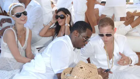 Getty Images Paris Hilton, Kim Kardashian and Sean "Diddy" Combs are photographed at a 2006 White Party event. 