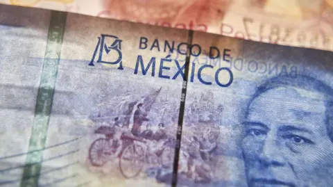 Getty Images A close up of a peso note