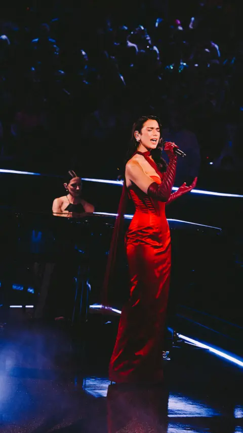 Lloyd Wakefield Dua Lipa performs in a red John Paul Gaultier dress at the Royal Albert Hall