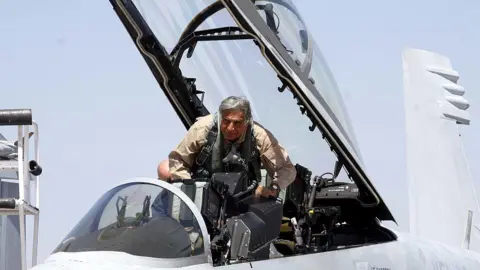 Getty images Tata Group Chairman Ratan Tata boarding a Boeing fighter F/A-18 Super Hornet at the Aero India 2011 at the Yelahanka air base on the outskirts of Bangalore on Thursday.