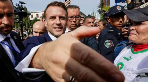 AFP France's President Emmanuel Macron greets people outside the parliament in Rabat on 29 October.