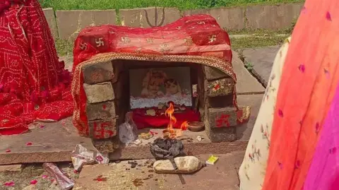 Mohar Singh Meena A lamp is lighted in front of the photograph of Roop and her husband at the place where they were cremated