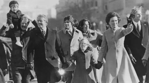 Getty Images Jimmy, Amy (C) and Rosalynn Carter (R) walk in the presidential inaugural parade in Washington DC in 1977