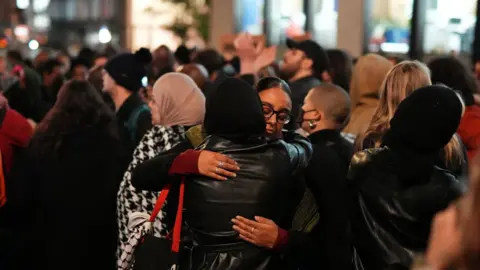 PA Media Two women embrace during a vigil outside the Old Bailey following the Chris Kaba verdict on Monday