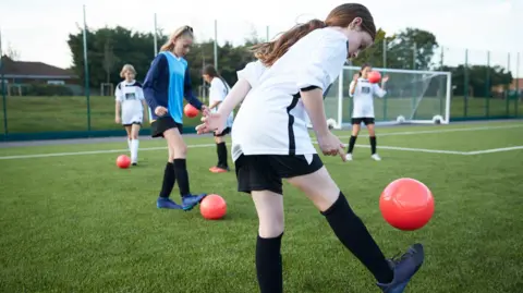 Getty Images A group of girls playing football