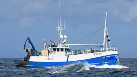 Fishing News Odyssey FR70 fishing boat at sea, blue and white trawler, amid waves