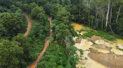 Reuters A drone view shows the excavated pits for illegal mining at the Prestea-Huni Valley Municipal District in the Western Region, Ghana, on 17 August 2024