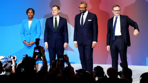 PA Media The four Conservative leadership candidates together on stage after delivering their speeches at the Conservative Party conference