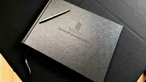 Scottish Parliament A black book of condolence sits on a black table.