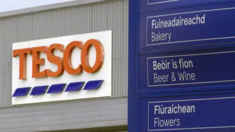 Getty Images Tesco in Stornoway with Tesco sign in background and a blue sign in the foreground