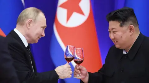 Getty Images Russian President Vladimir Putin and North Korean leader Kim Jong Un toast during a reception at the Mongnangwan Reception House in Pyongyang on June 19, 2024