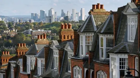 Getty Images Houses and large tower blocks in the distance