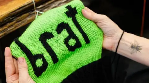 Getty Images A picture of a hat named Brat that was knitted in support of Kamala Harris, by Annette Corsino, owner of the Knitting Tree LA