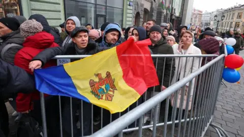 EPA-EFE/REX/Shutterstock Moldovans wait to vote in Moscow