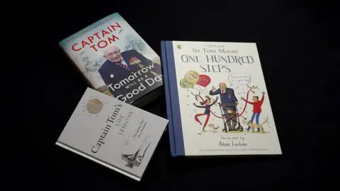 Andy Meeson/BBC A display of Captain Tom's three books; Tomorrow Will Be a Good Day; One Hundred Steps, and Captain Tom's Life Lessons