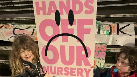 Suzanne Trotter Children hold up campaign placards saying "Hands off our nursery"