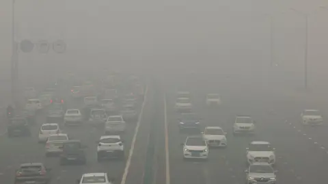 Reuters Traffic passes on a road as the sky is enveloped with smog after Delhi's air quality turned "severe" due to alarming air pollution, in New Delhi, India, November 18, 2024.