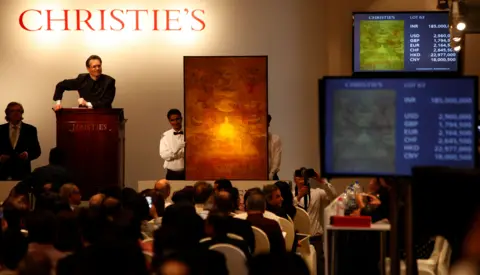 Getty Images Auctioneer Hugo Weihe interacts with bidder on Vasudeo S Gaitonde's (1924-2001) untitled oil painting painted in 1979, at India's first South Asia Art organized by Christie's at Taj Mahal hotel, on December 19, 2013 in Mumbai, India. 
